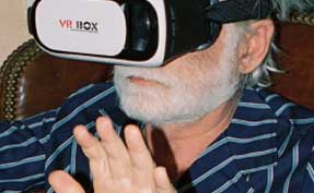 Elderly man wearing VR BOX virtual reality headset