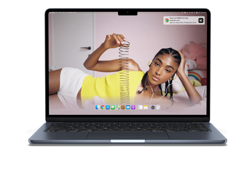 Laptop displaying woman lying down holding a spring