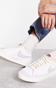 Person wearing white Nike sneakers and jeans