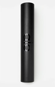 Black cylindrical container with embossed letters