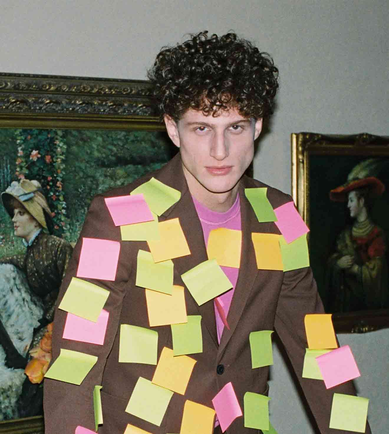 Man wearing suit covered in colorful sticky notes
