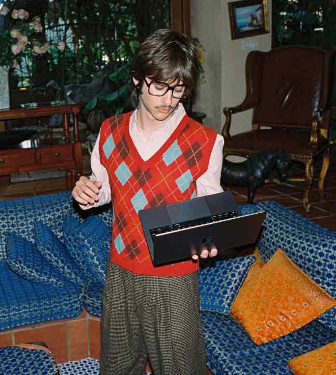 Person with glasses using a laptop indoors