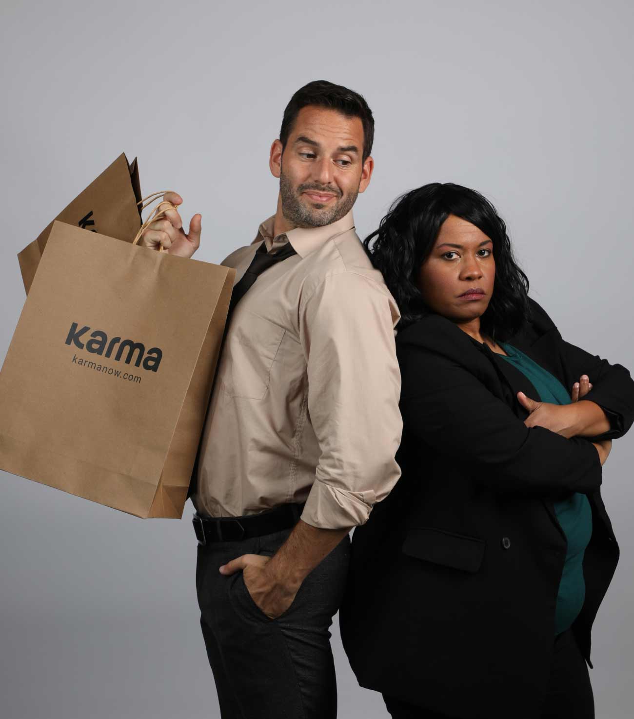 Man with shopping bags and woman standing back-to-back