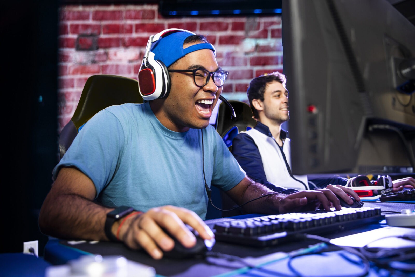 Two men enjoying competitive video gaming