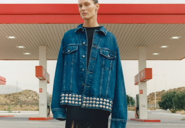 Woman wearing oversized denim jacket with studs