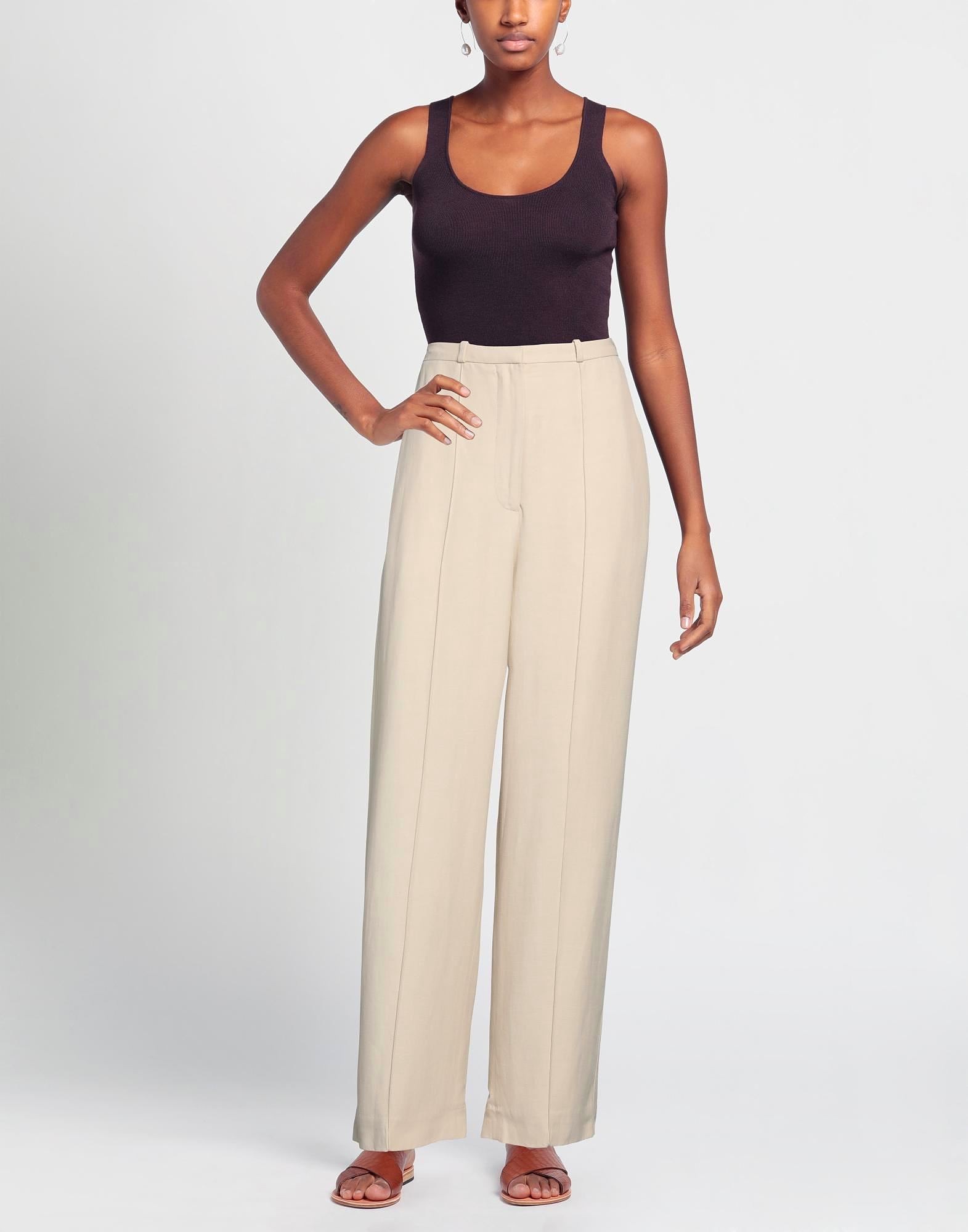 Woman wearing beige wide-leg pants and black tank top