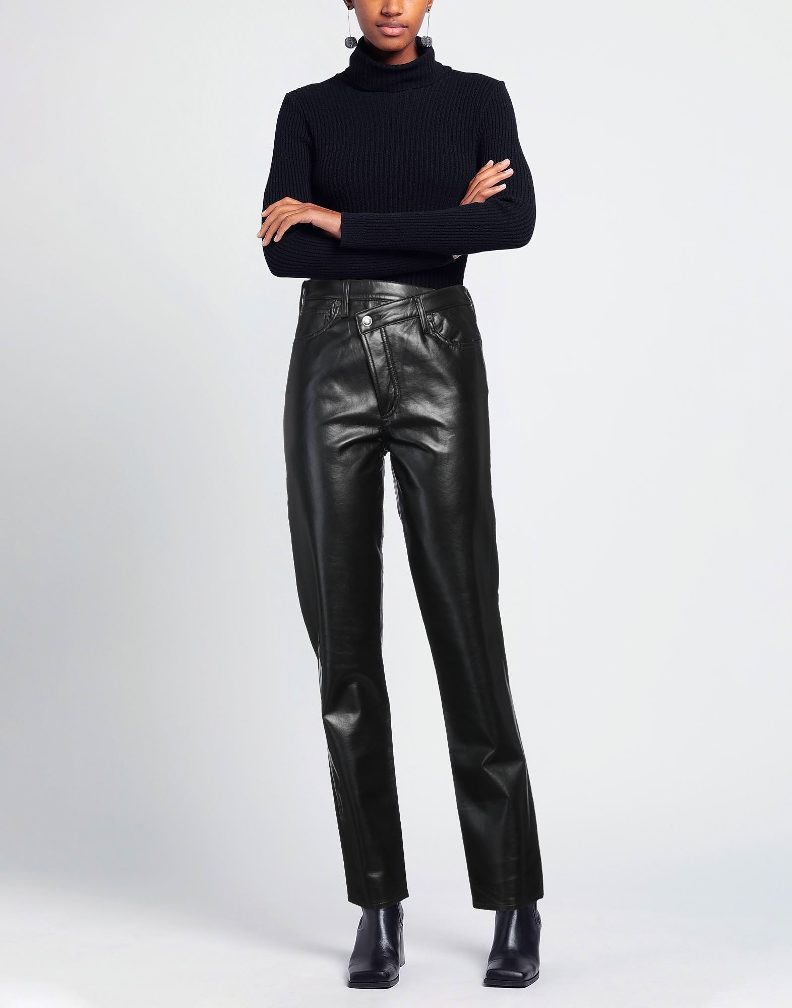 Woman wearing black leather pants and black turtleneck