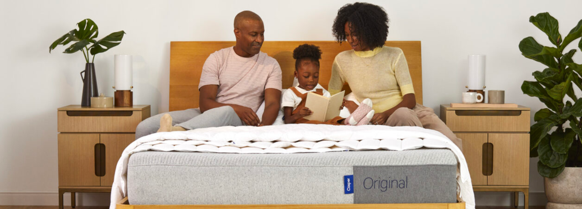 Family reading together on bed with Casper mattress
