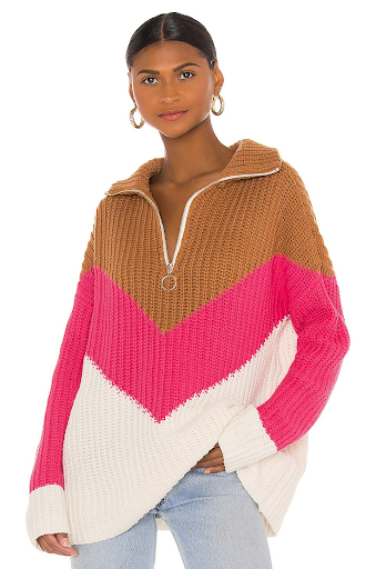 Woman wearing color-block knit sweater with zipper