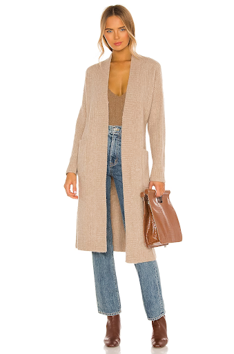 Woman wearing beige long cardigan and jeans