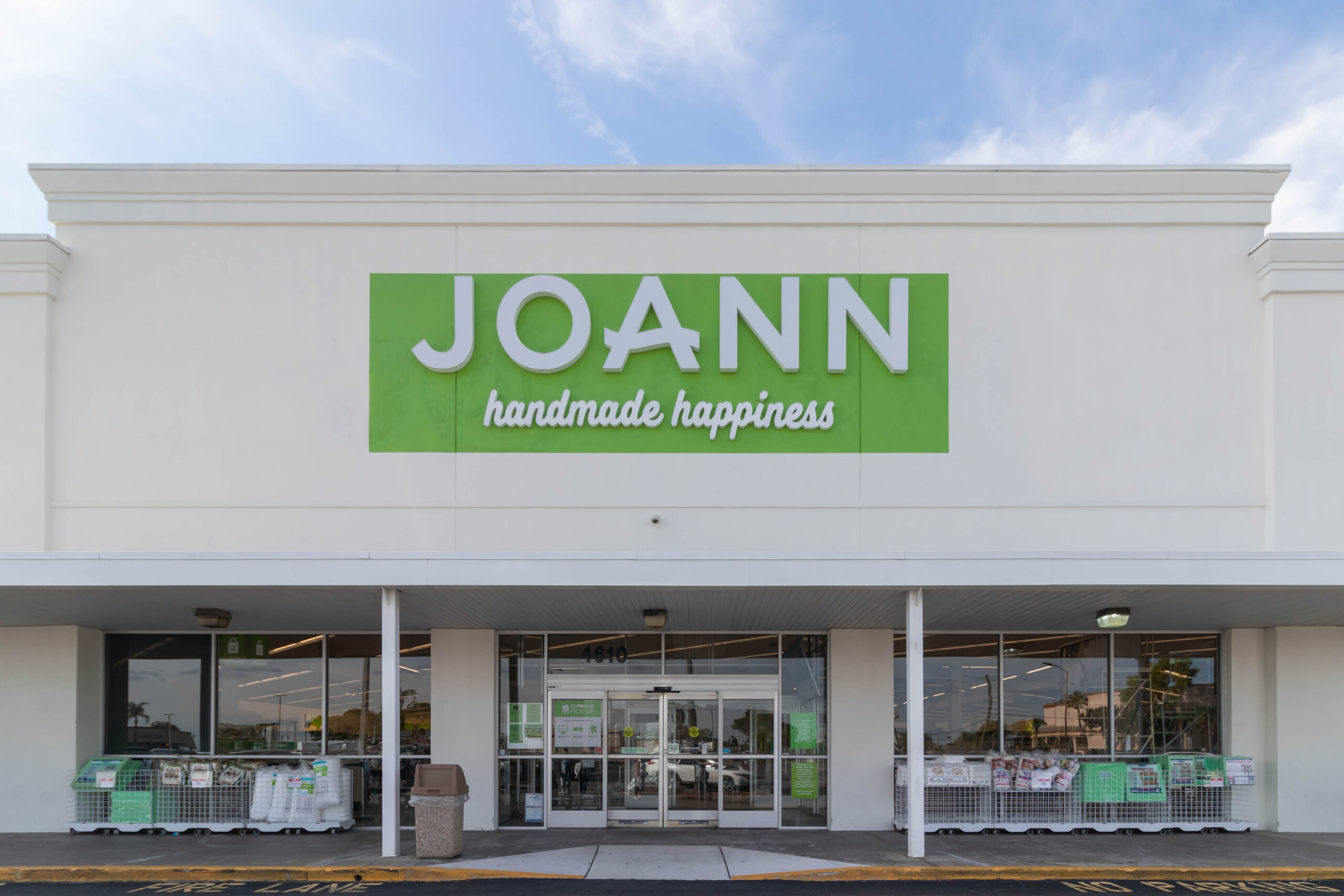 Joann store front with handmade happiness sign