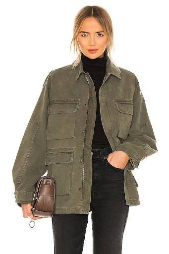 Woman wearing oversized green jacket and black pants