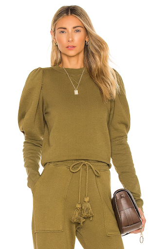 Woman in olive green puff sleeve sweater and pants