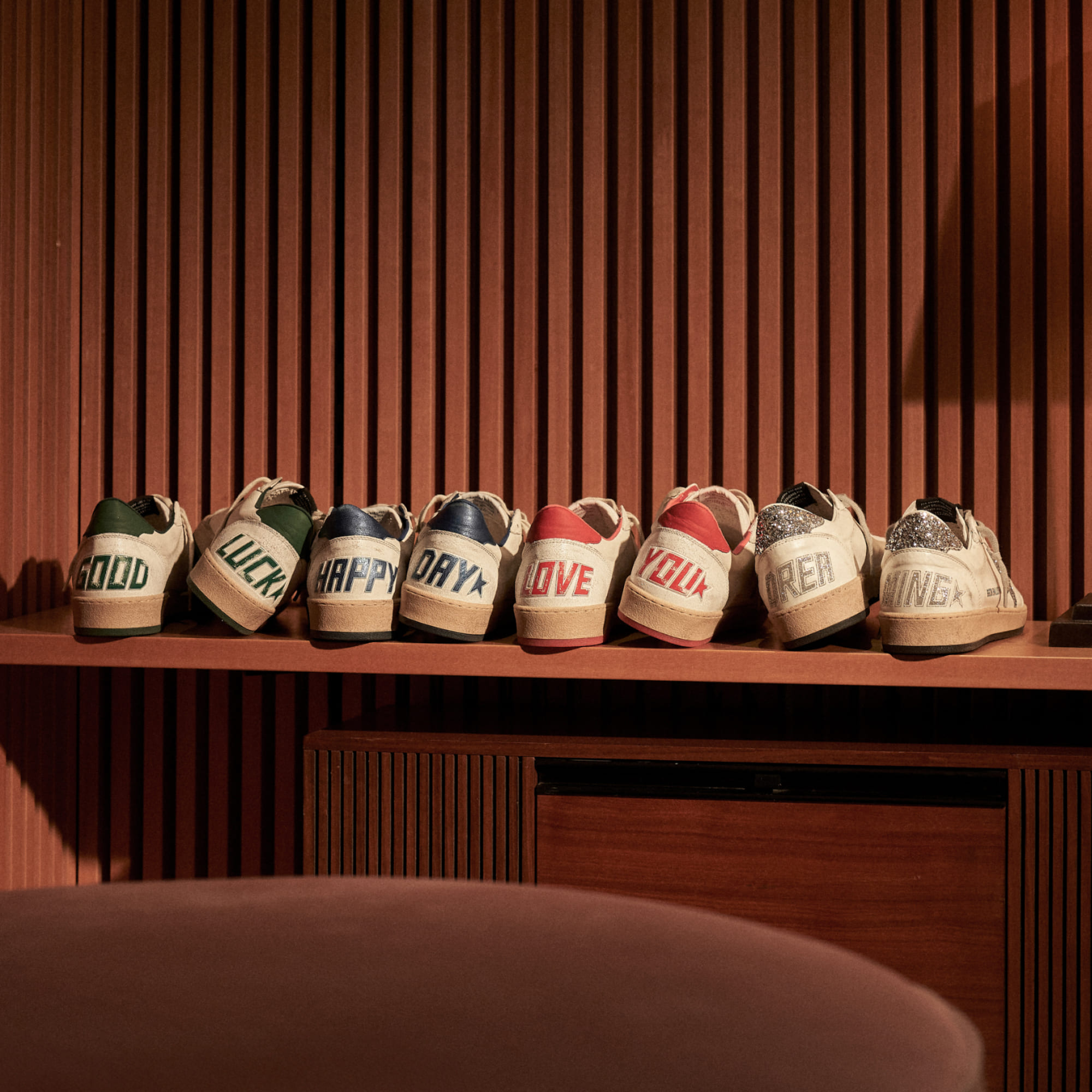 Row of shoes with words spelled out on heels