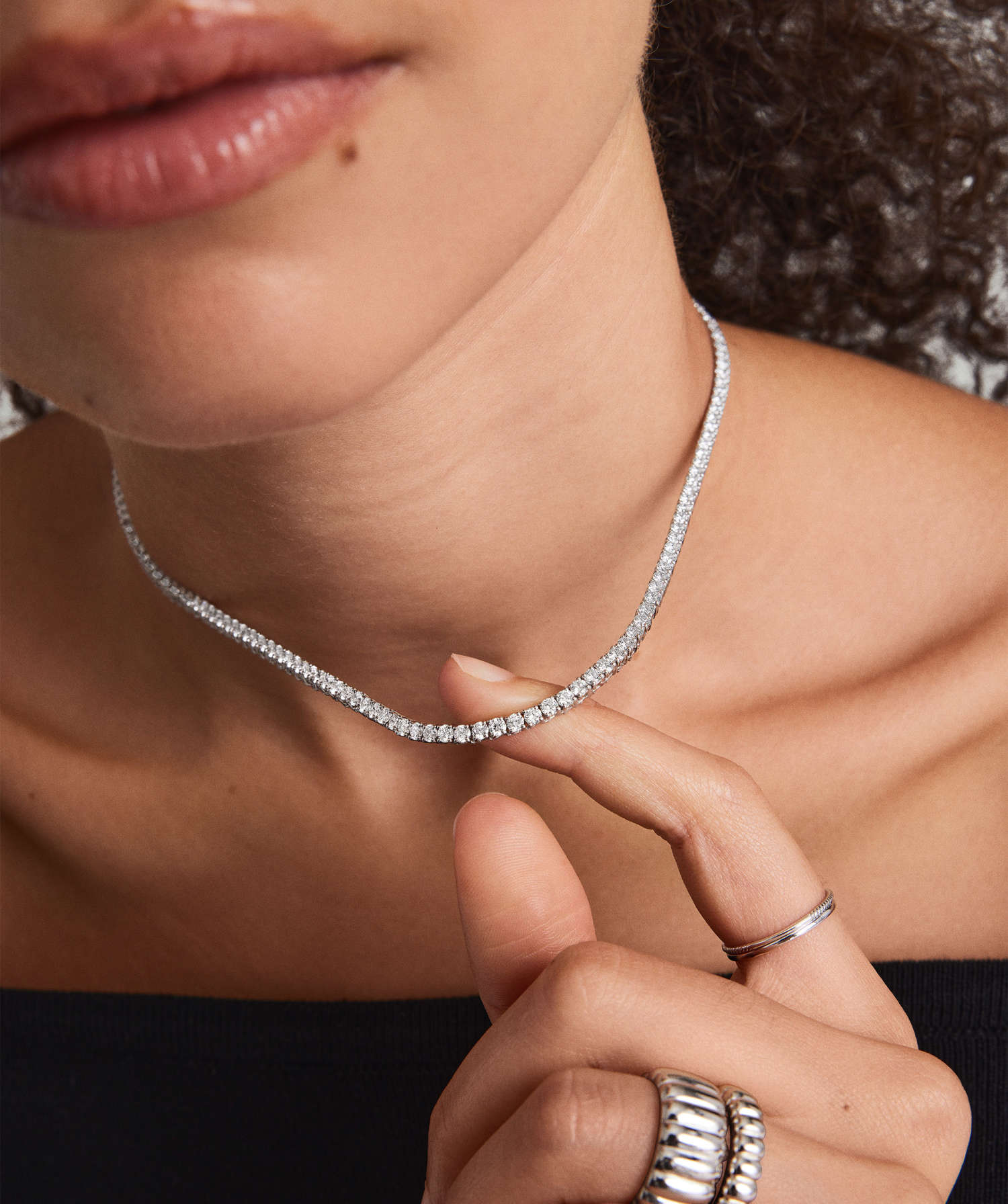 Close-up of diamond necklace on woman's neck