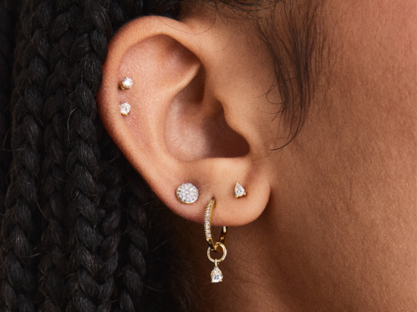 Ear with multiple diamond and gold earrings