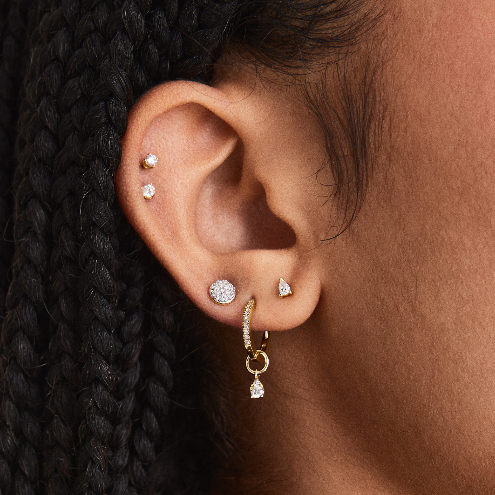 Ear with multiple diamond and gold earrings