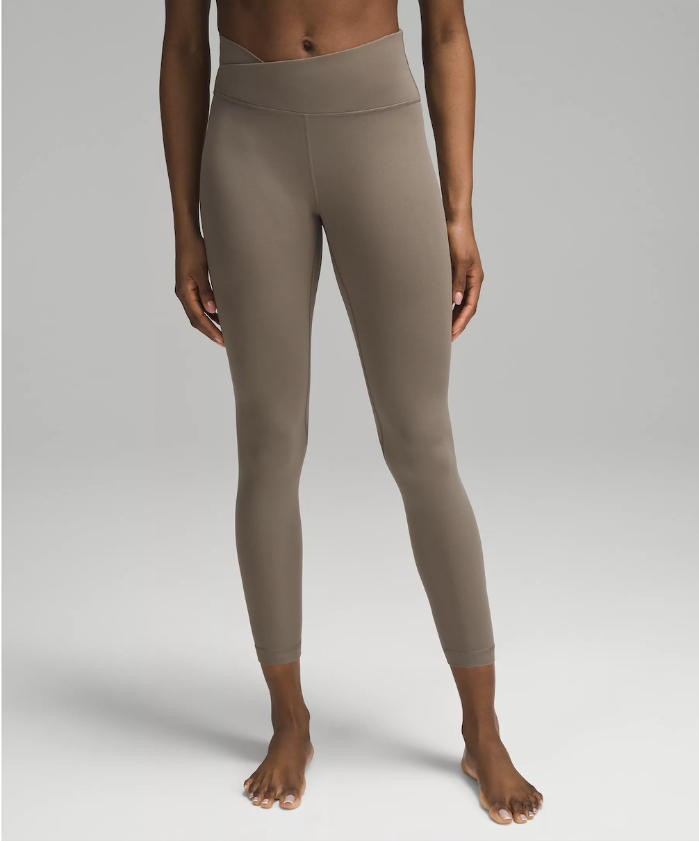 Woman wearing high-waisted brown leggings barefoot