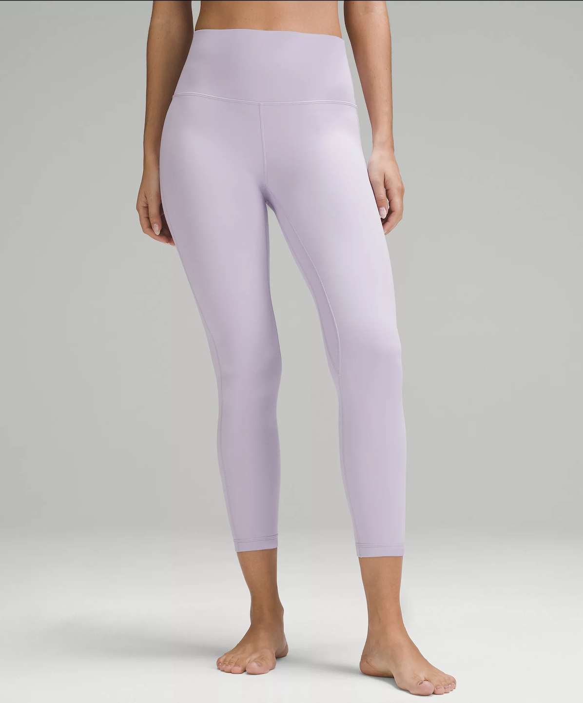 Woman wearing light purple cropped leggings barefoot