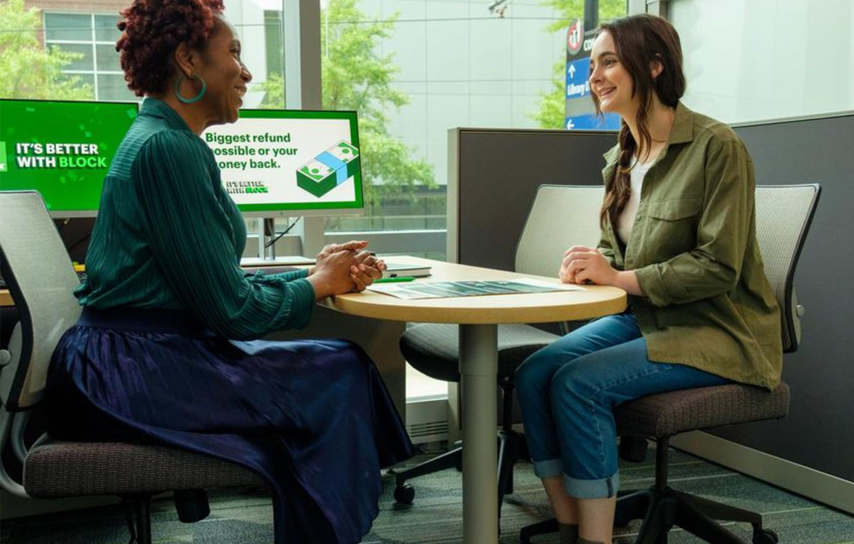 Two women smiling during office meeting
