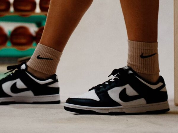 Person wearing black and white Nike sneakers and socks