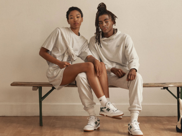 Two people in casual beige outfits sitting on a bench