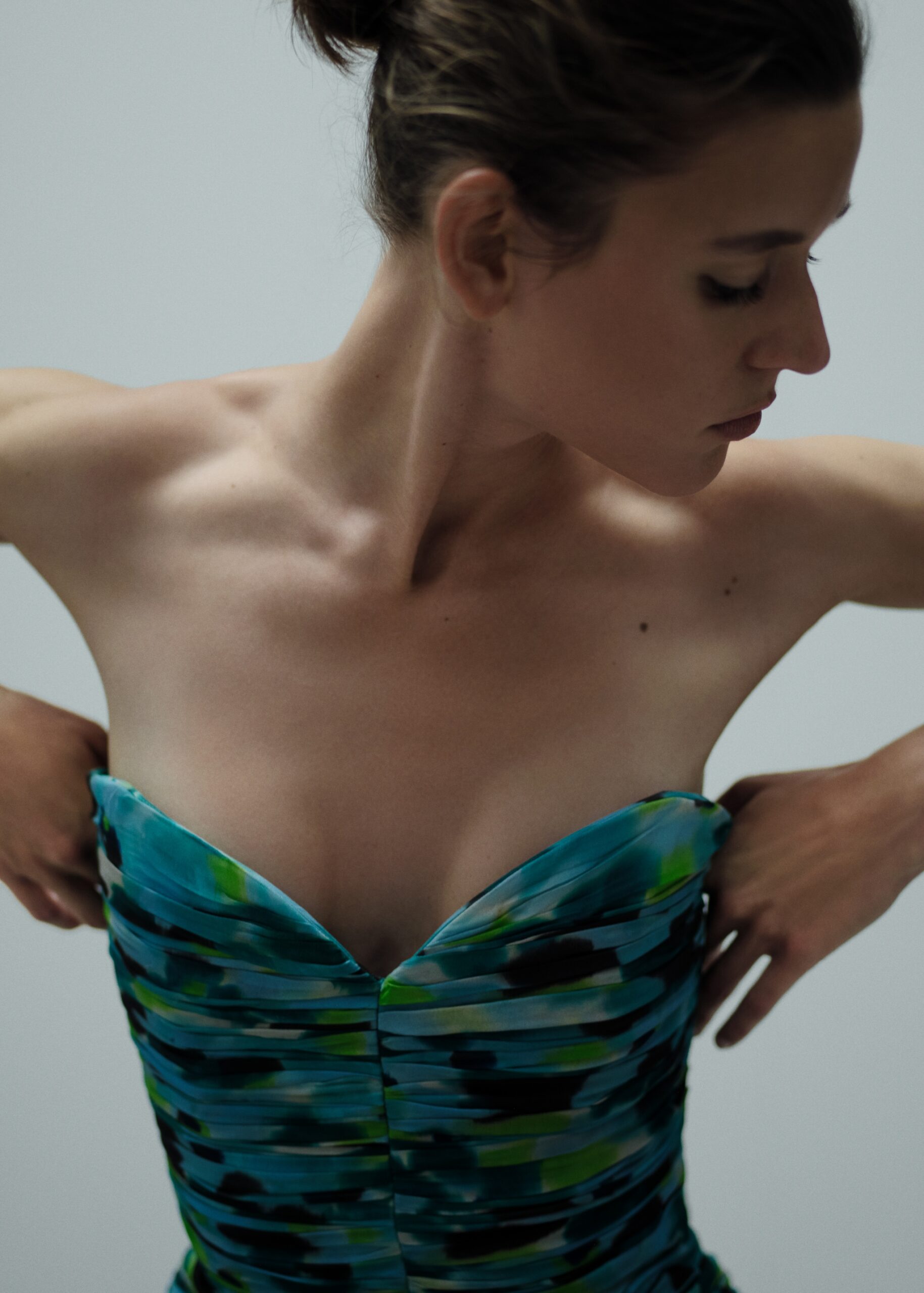 Woman adjusting colorful strapless dress