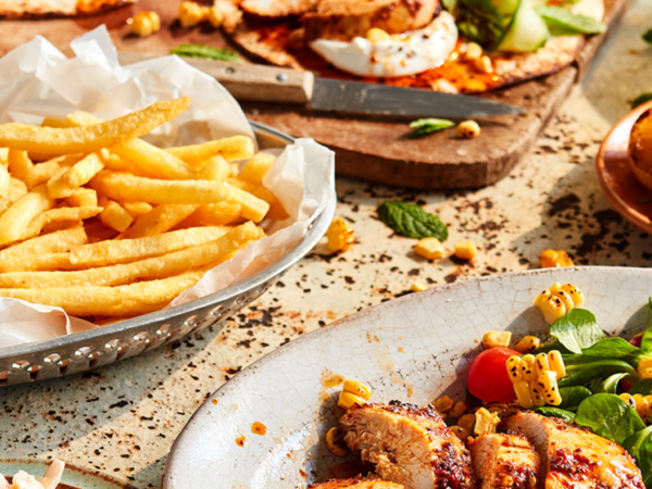 Grilled chicken with salad, fries, and tortillas