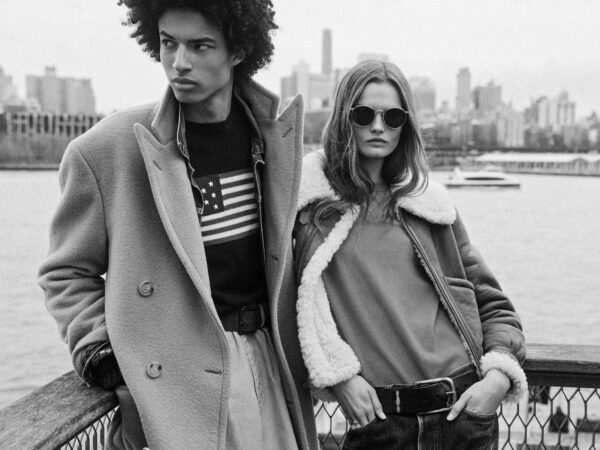 Stylish man and woman in coats by waterfront