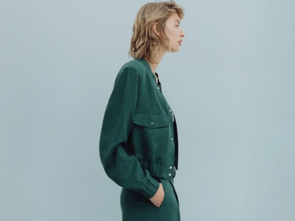 Profile of woman wearing green jacket and trousers