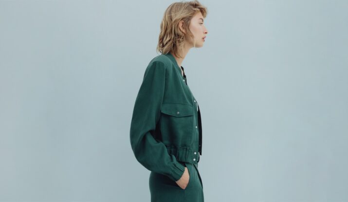 Profile of woman wearing green jacket and trousers
