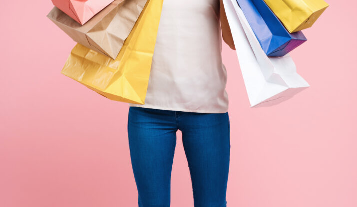 Happy woman holding colorful shopping bags