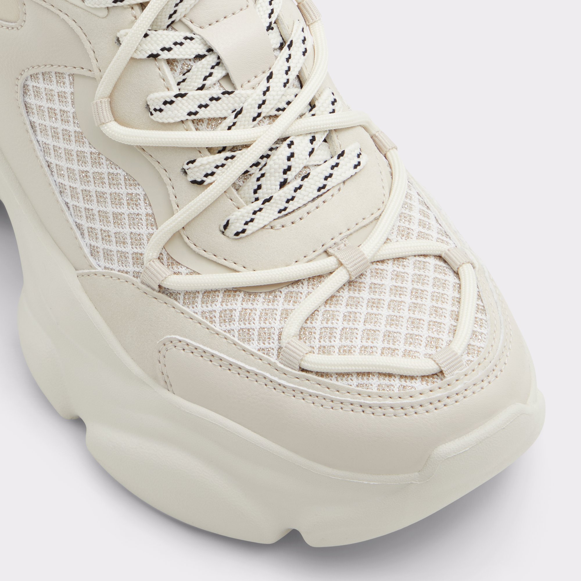 andree_white_110-002-043_alt4_sq_gy_2000x2000 Close-up of beige sneaker with patterned laces