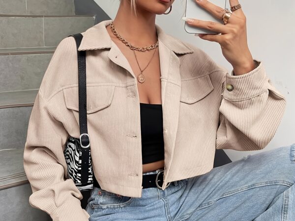 woman wearing beige cropped jacket and sunglasses