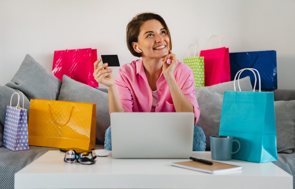 Smiling woman online shopping with credit card