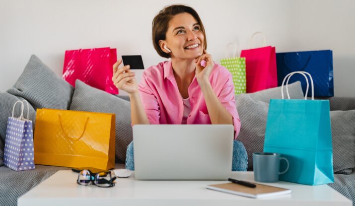 Smiling woman online shopping with credit card