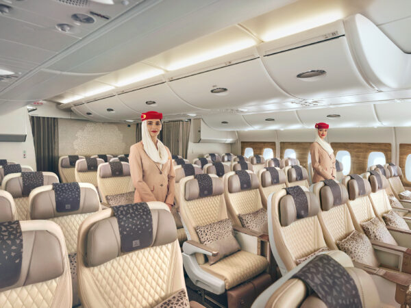 Two flight attendants in spacious airplane cabin seating