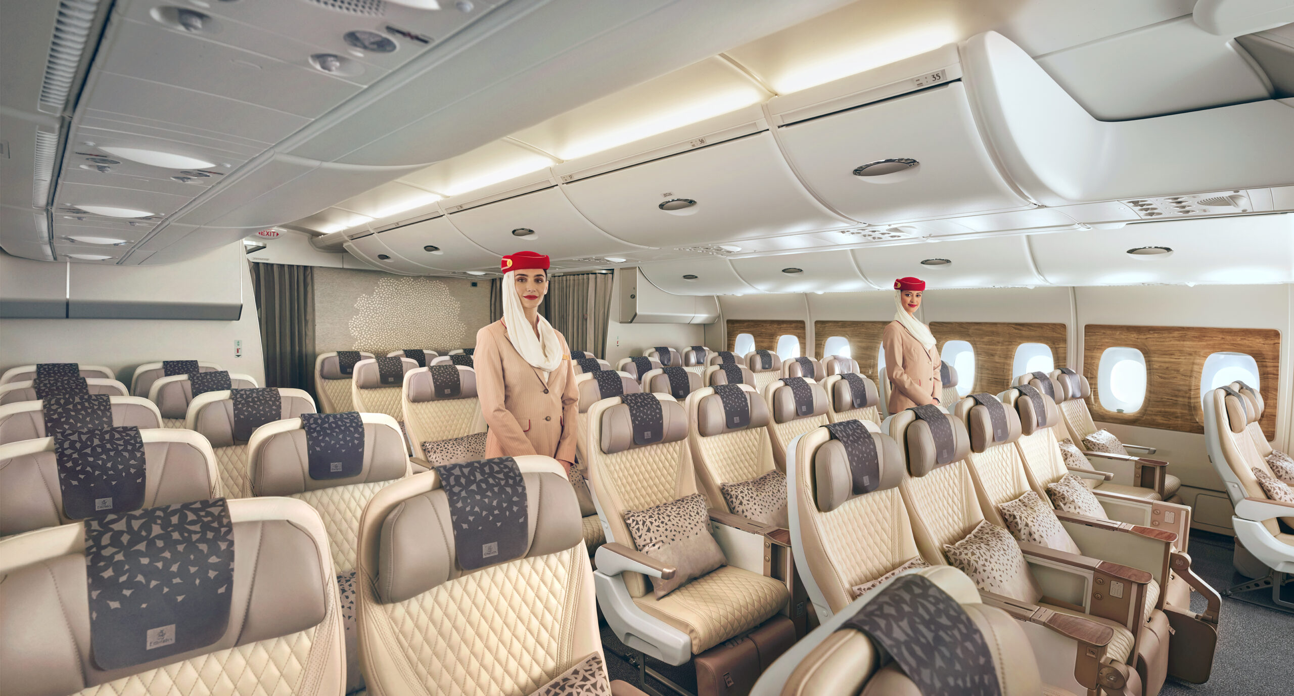 Two flight attendants in spacious airplane cabin seating