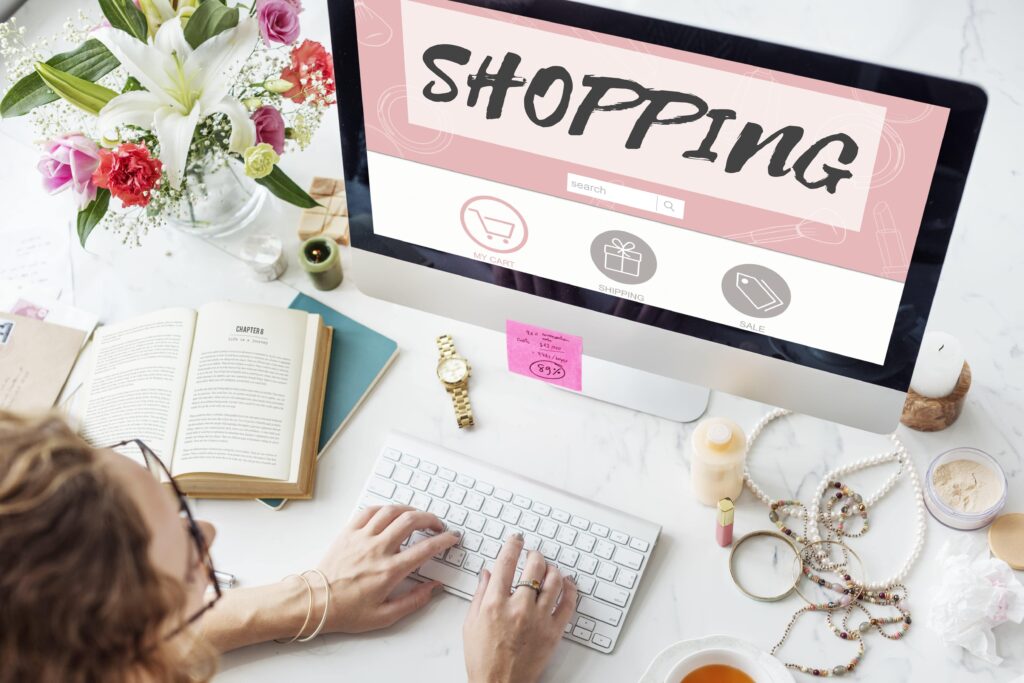 Person typing on keyboard with online shopping screen