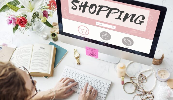 Person typing on keyboard with online shopping screen
