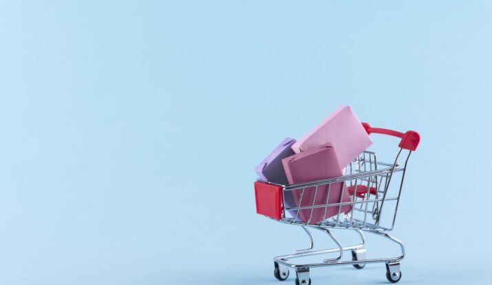 Mini shopping cart with wrapped pastel gifts