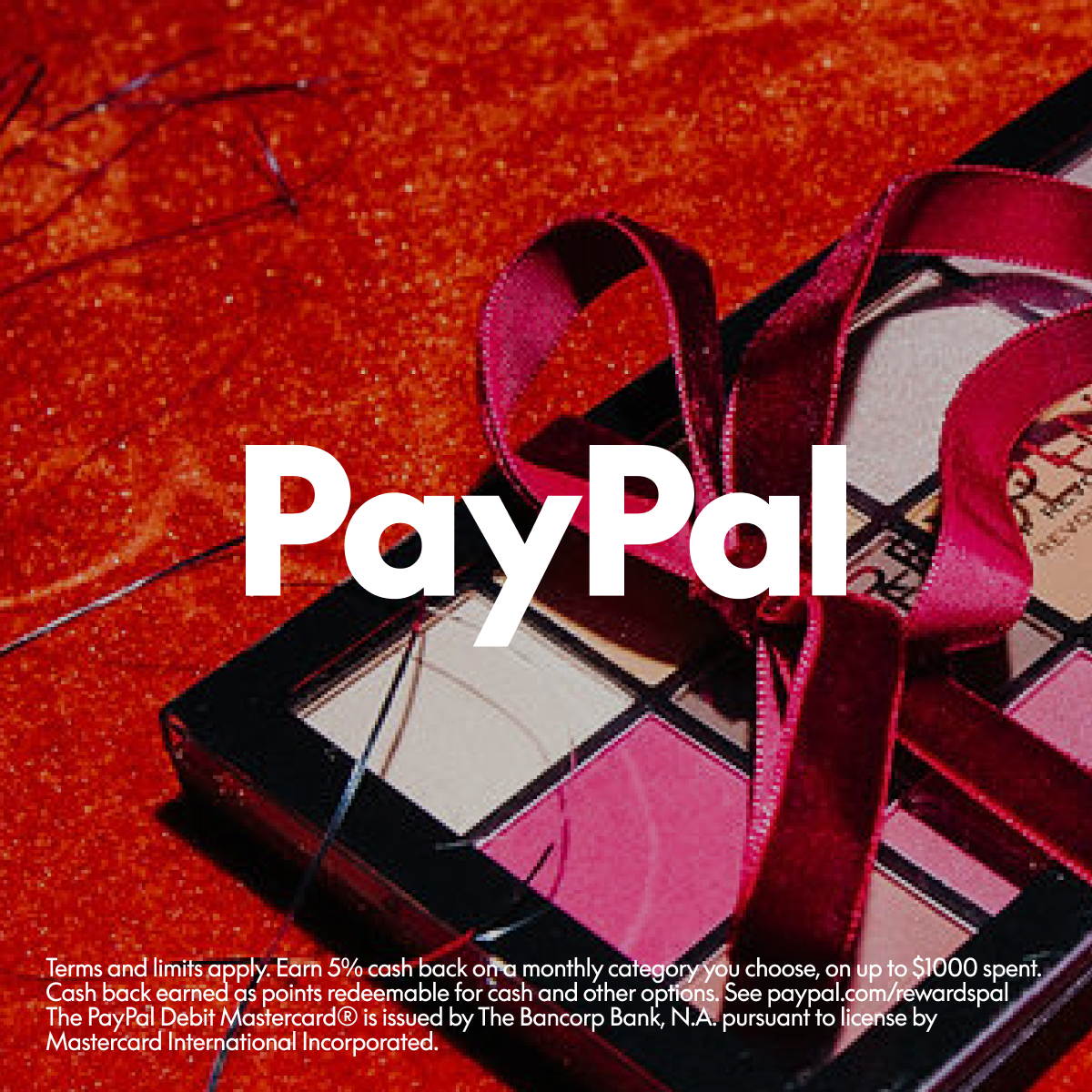 Red ribbon on a gift box with PayPal logo