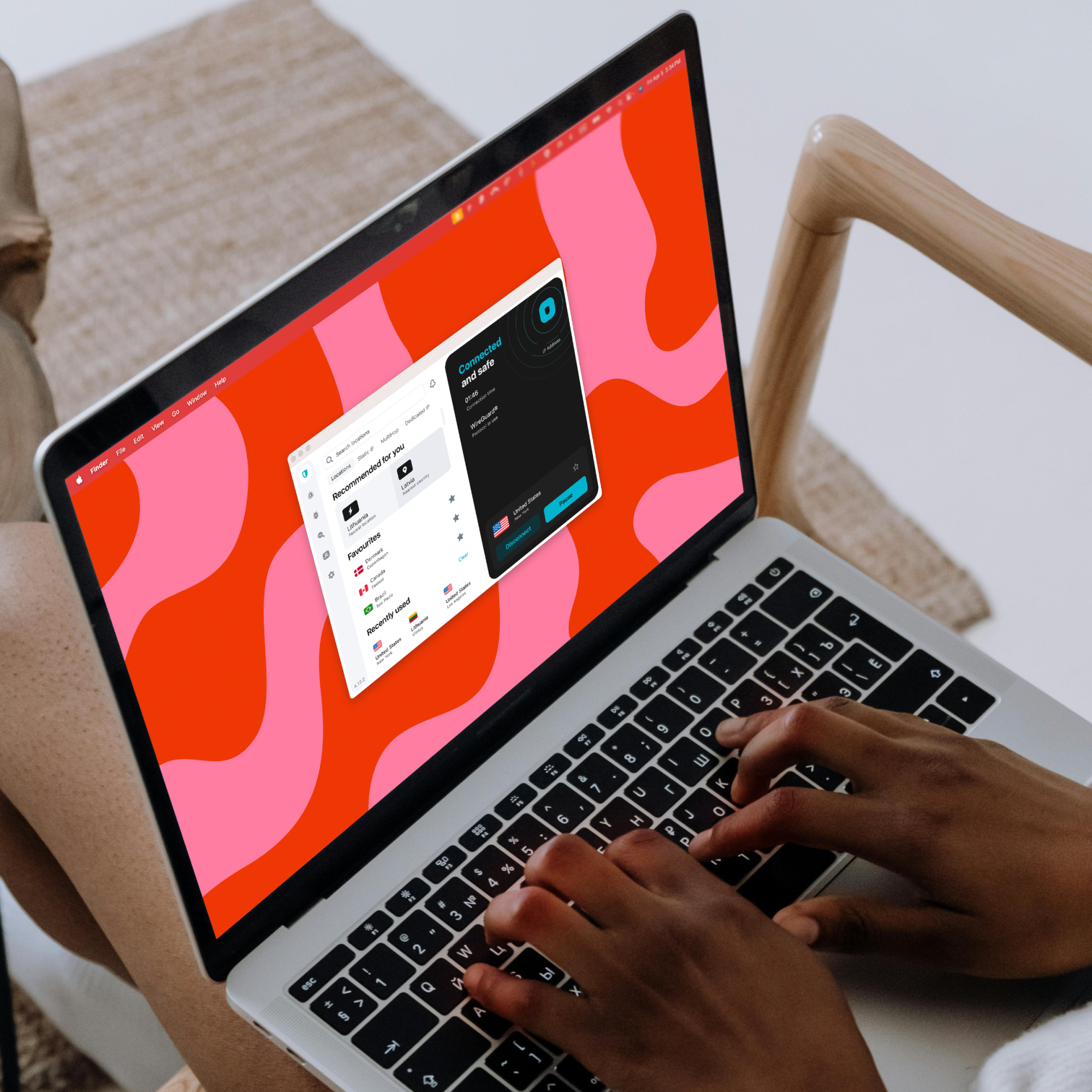 Person typing on laptop with VPN app open