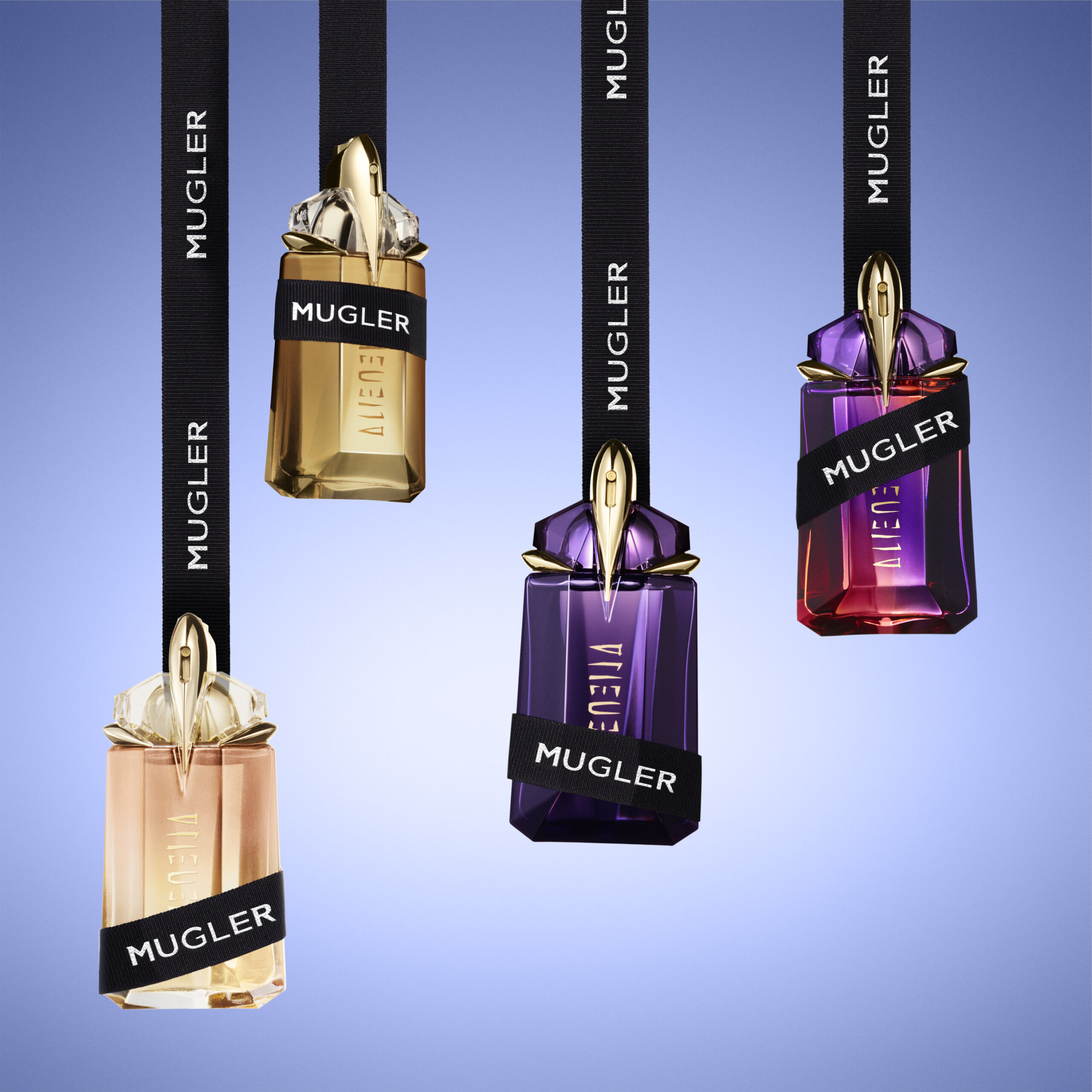 Four hanging Mugler Alien perfume bottles with ribbons