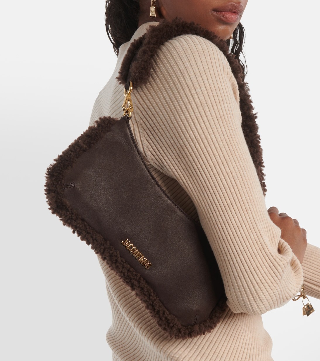 Woman carrying brown shearling Jacquemus shoulder bag