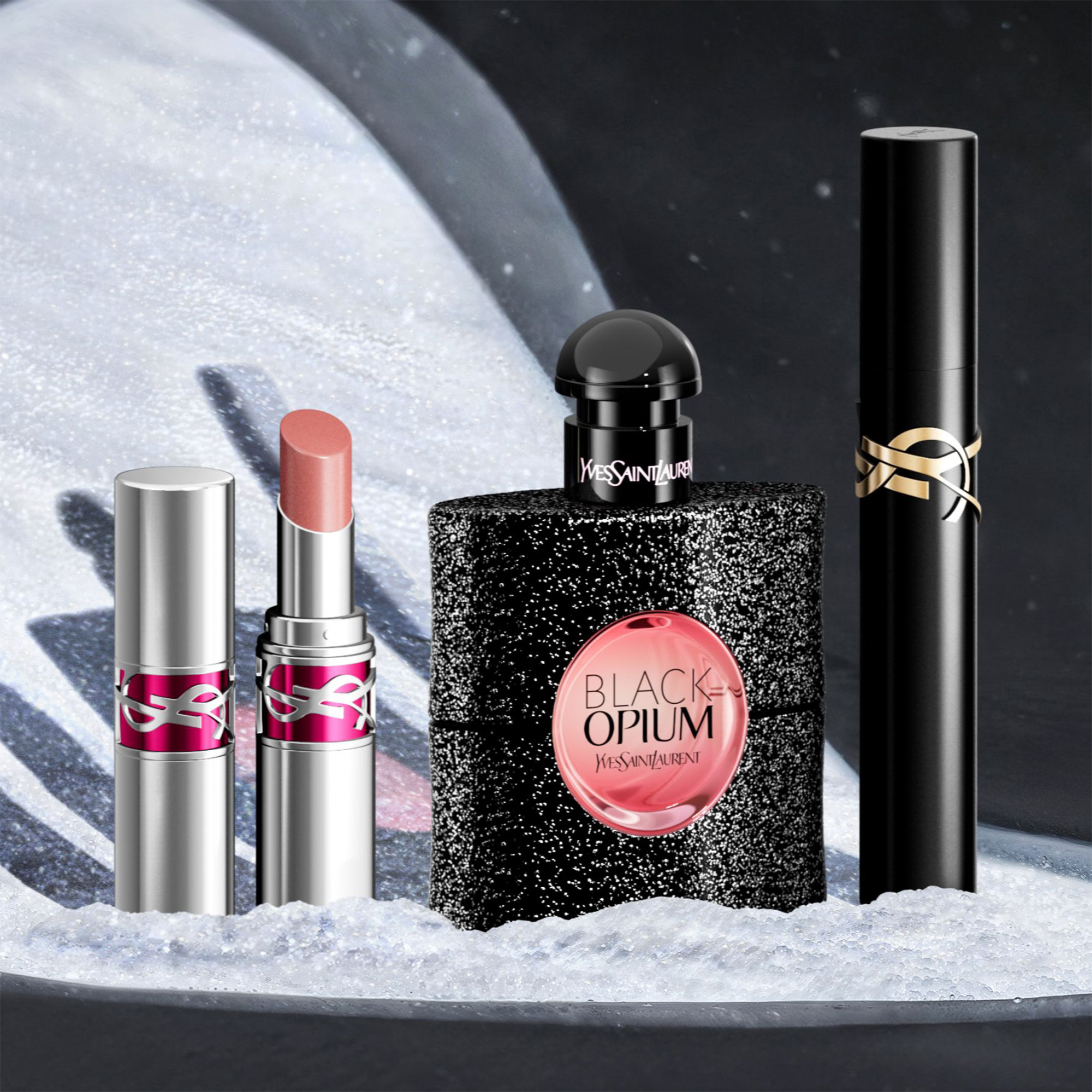 Yves Saint Laurent lipstick, perfume, mascara on snow