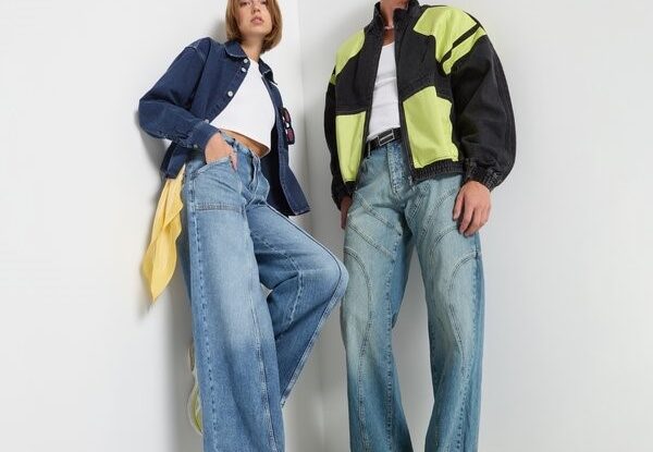 Two models wearing wide jeans and casual jackets
