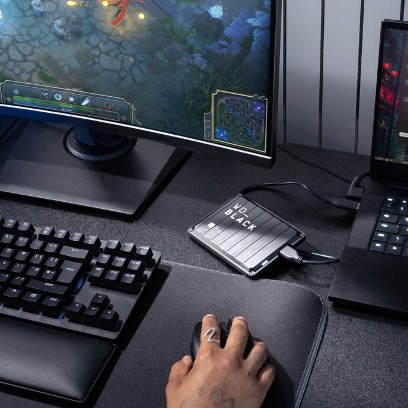 Person gaming on computer with external WD Black drive