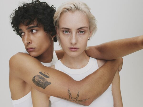 Two people embracing, intense gaze, white tops