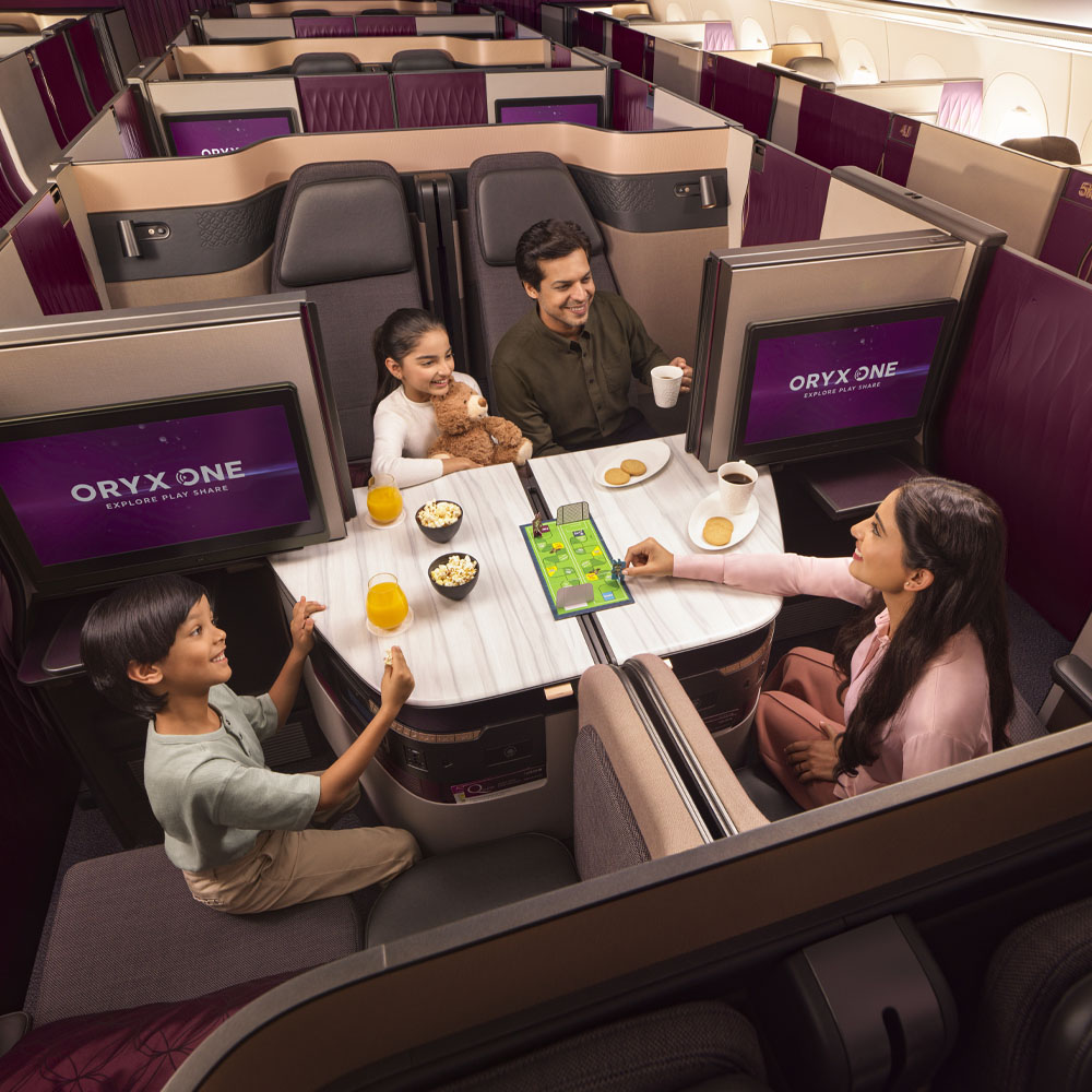 Family playing board game in luxury airplane cabin